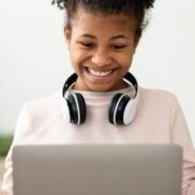 Little Winner. Excited Black Girl At Laptop Gesturing Yes Getting A-Grade During Webinar At Home. Online School Tests Concept