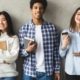 Multiethnic group of university students against college grey wall, panorama