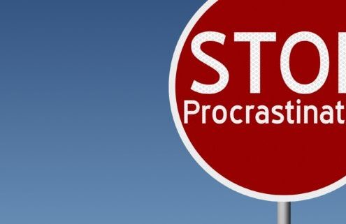 Round highway road sign with text stop procrastination