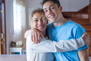 Mother and teenage son happy and showing affection.